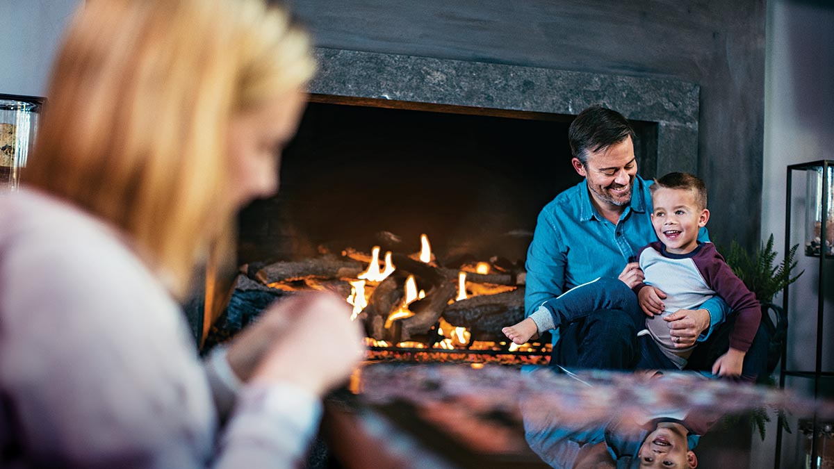 Family in Front of Propane Fireplace Installed by M&M Oil & Propane in Charleston, South Carolina